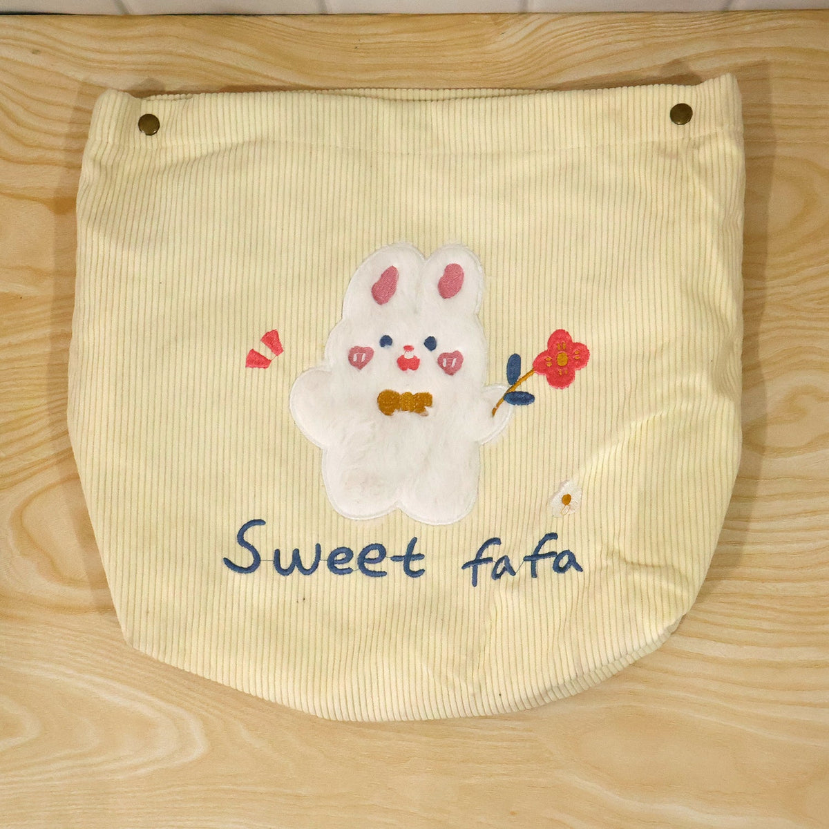Foldable fabric storage basket by Wukusy with snap closure, ideal for toys, clothes, and home organization.