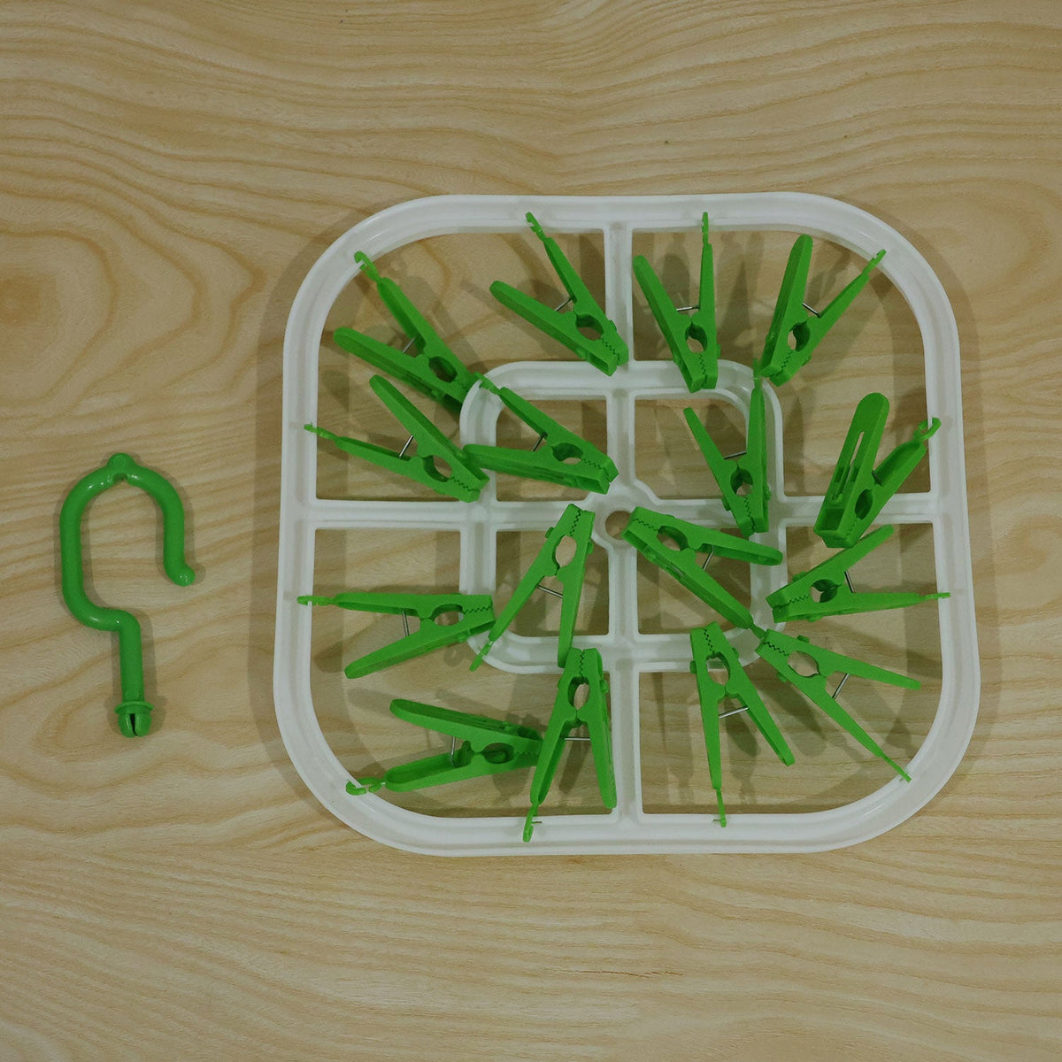 Wukusy plastic clip hanger drying rack with detachable hook for socks and small clothes, hanging on a line.