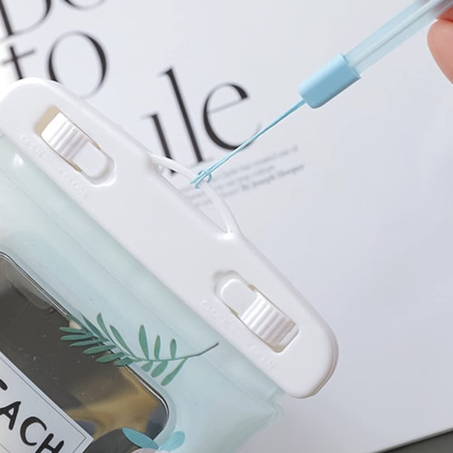 Clear waterproof mobile pouch with peach tint and neck strap by Wukusy, designed for secure phone protection during water activities.