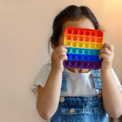 Wukusy rainbow-colored push pop bubble fidget sensory toy with mixed pattern design for stress relief and sensory play.