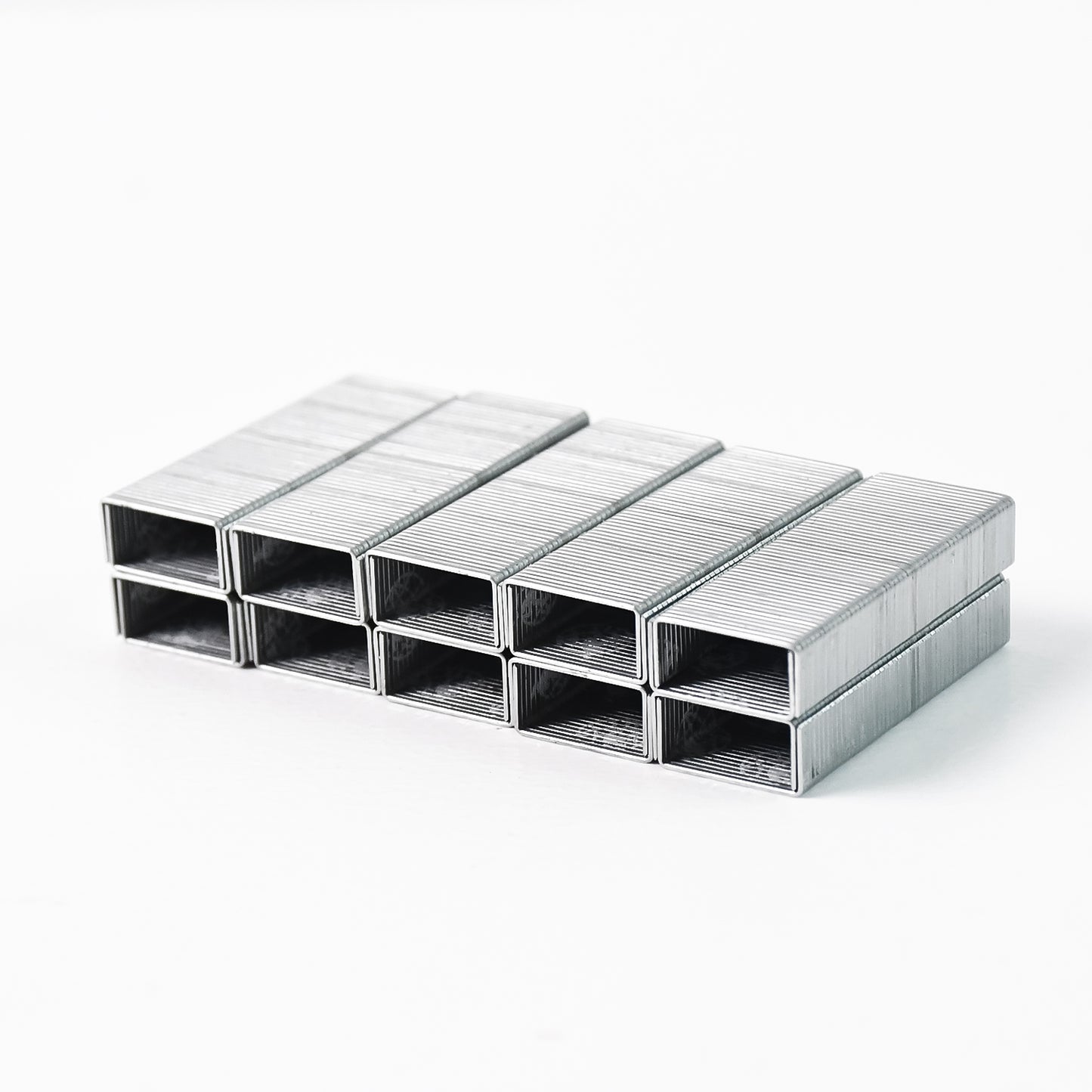 Wukusy Kangaro 246-1m high-quality steel staples for office use, durable steel pins stacked neatly in an office setting.