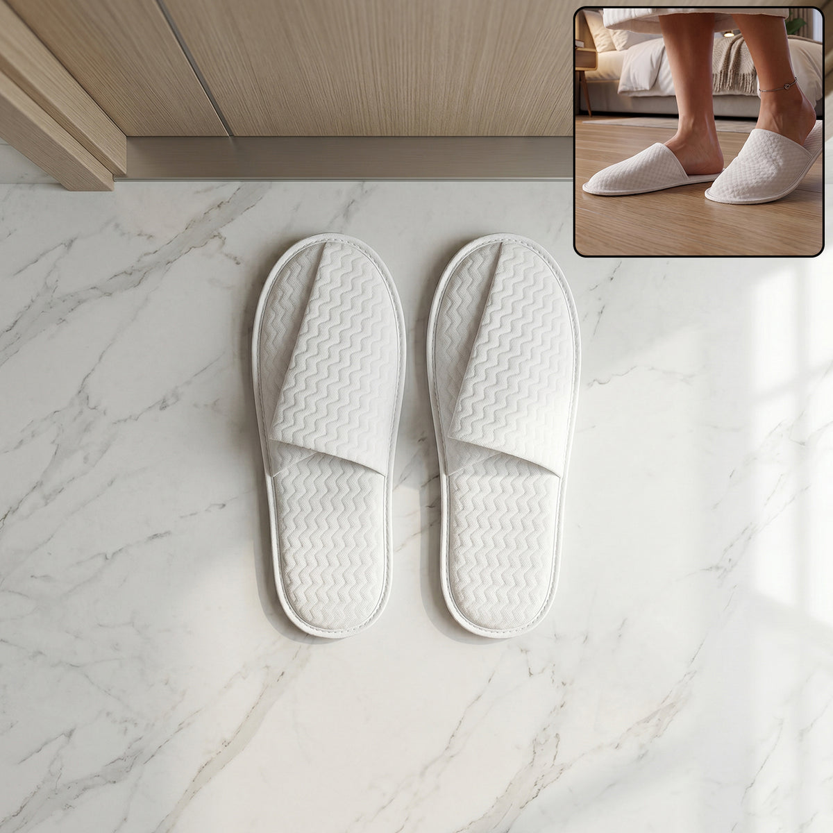 Pair of white disposable hotel slippers for guests by Wukusy, shown in a clean, open-toe design on a hotel room floor.