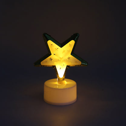 Four decorative star-shaped flameless LED candles by Wukusy for home decor, glowing softly in a stylish display.
