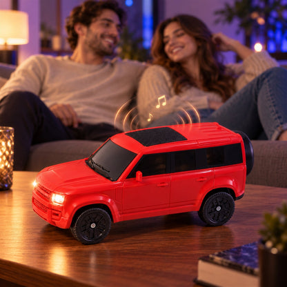Wukusy car-shaped wireless speaker with light-up headlights and audio controls, featuring a sleek design and Bluetooth connectivity.