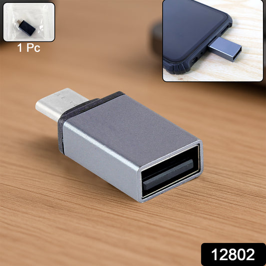 Wukusy Type-C OTG adapter pen drive connected to a smartphone, compact black USB-C to USB flash drive accessory.