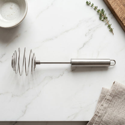 Wukusy stainless steel large round spring whisk egg beater for kitchen cooking, showing its sturdy handle and wire whisk design.
