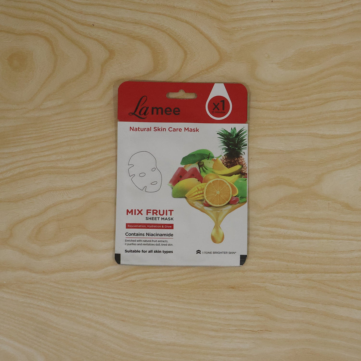 Wukusy mix fruit facial sheet mask with niacinamide for hydrating skin, shown on a skincare display with fresh fruit slices