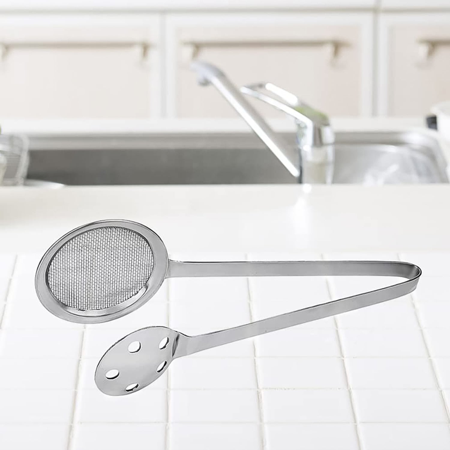 Wukusy Apex stainless steel skimmer serving tong with ergonomic handle for kitchen use, ideal for serving and straining food.