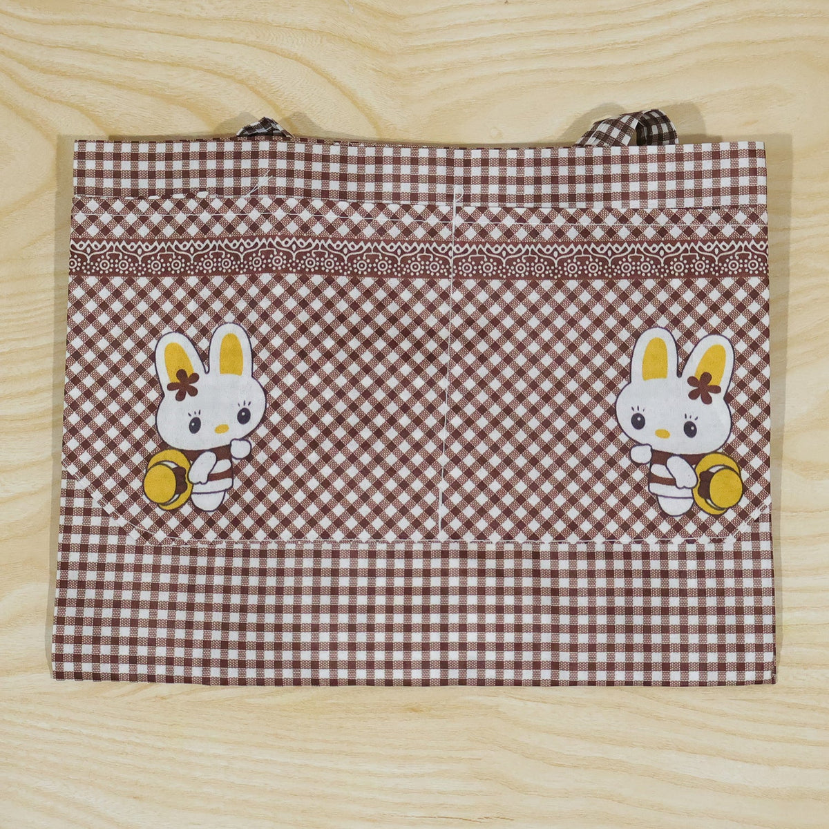 Kids cartoon kitchen cooking apron with front pockets by Wukusy, featuring colorful playful design, 71 x 57 cm size.