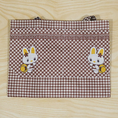 Kids cartoon kitchen cooking apron with front pockets by Wukusy, featuring colorful playful design, 71 x 57 cm size.