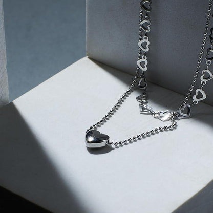 Salty Falling In Love silver necklace by Drpshippr featuring a delicate chain and charming pendant on a white background.