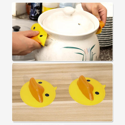 Pair of Wukusy cute duck-shaped silicone hot pot holders, heat-resistant kitchen accessories for handling hot cookware.