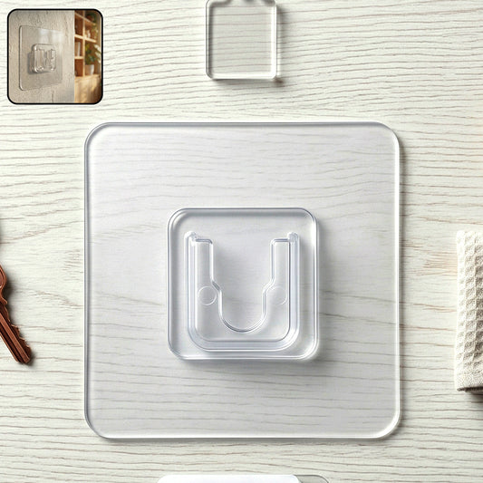 Transparent self-adhesive wall hook by Wukusy mounted on a wall, showing its clear design and adhesive backing for easy hanging.