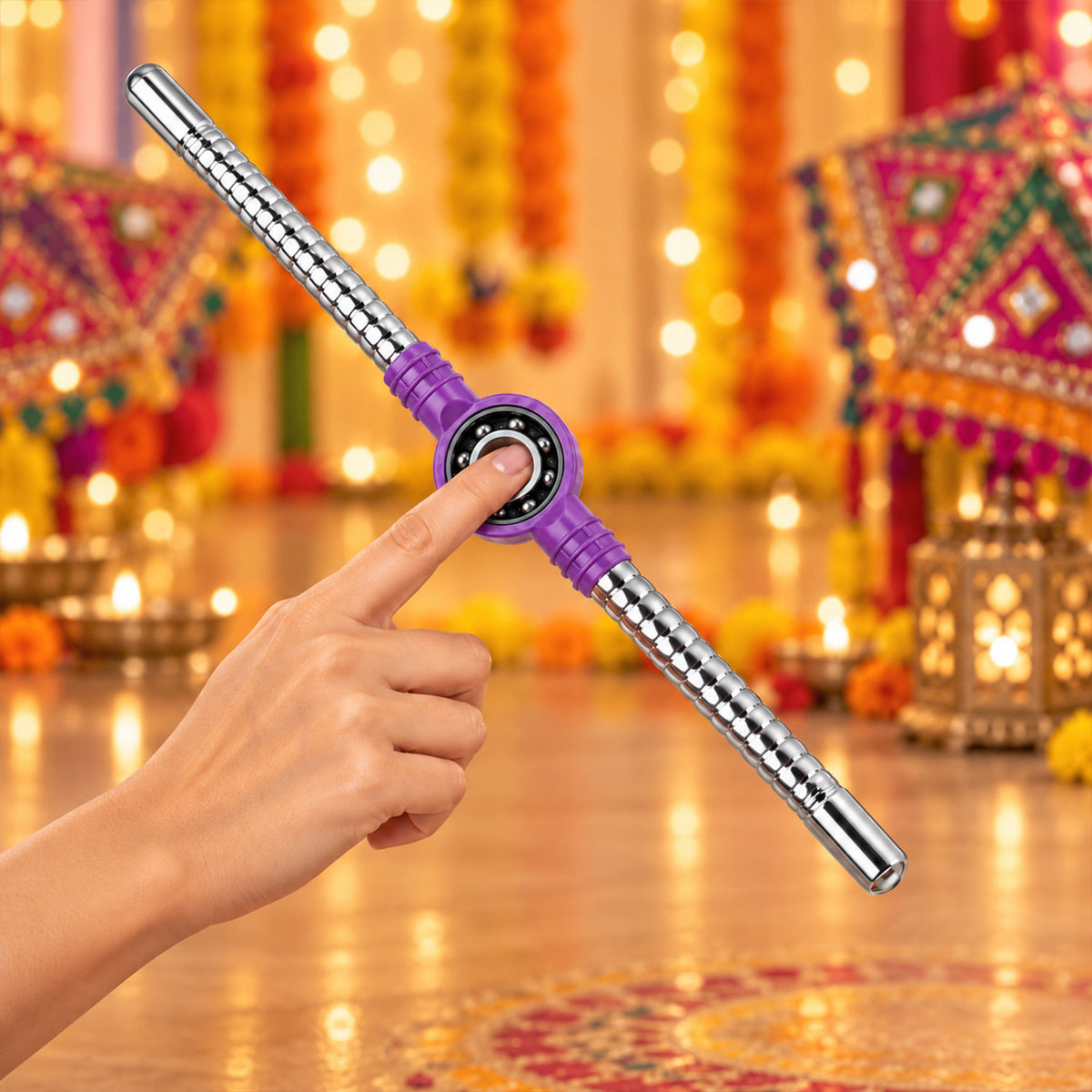 Pair of steel Dandiya sticks with textured grip, bearing center, and tassels, designed by Wukusy for traditional dance performances.
