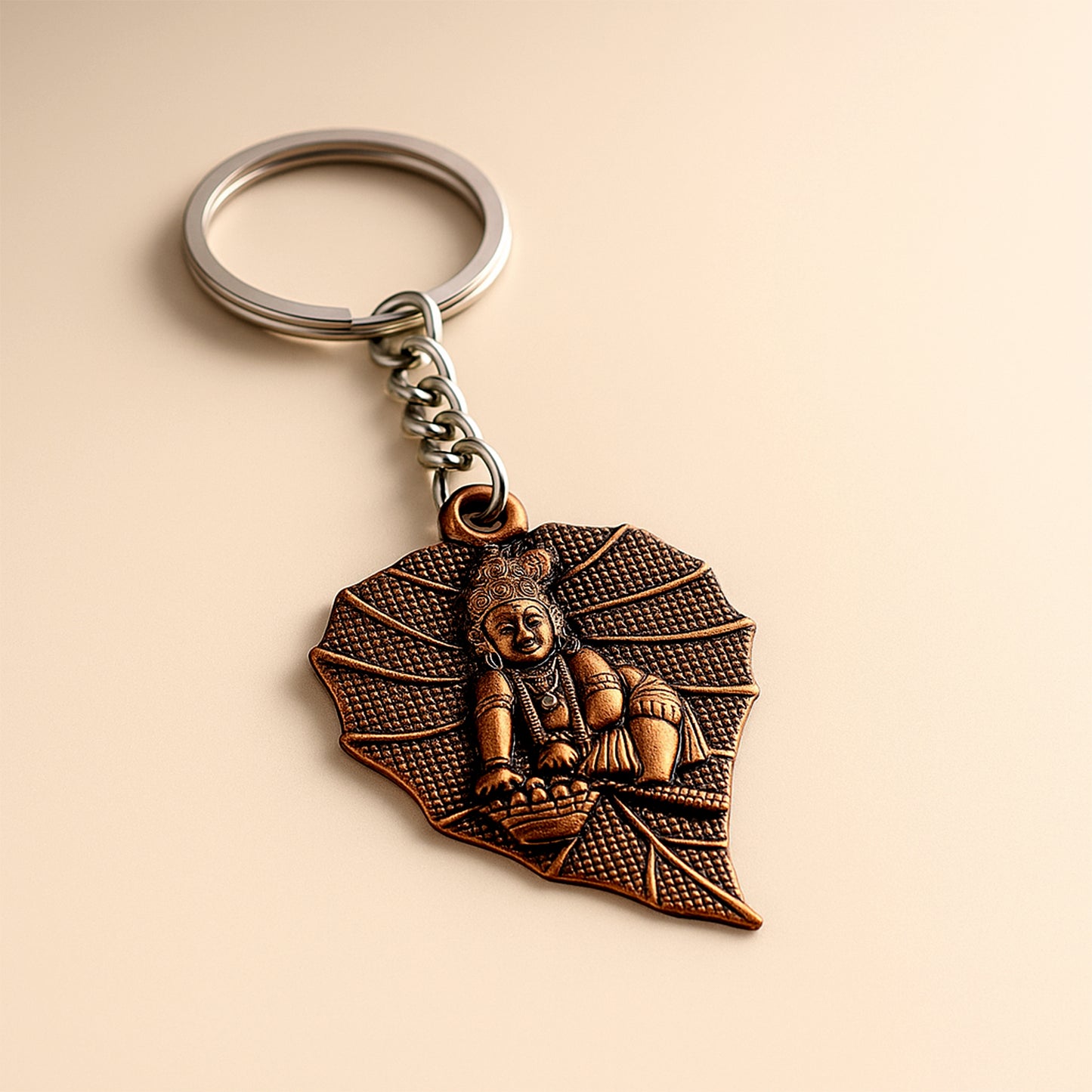 Antique-finish metal keychain by Wukusy with intricate design, featuring a durable metal loop for keys or accessories.