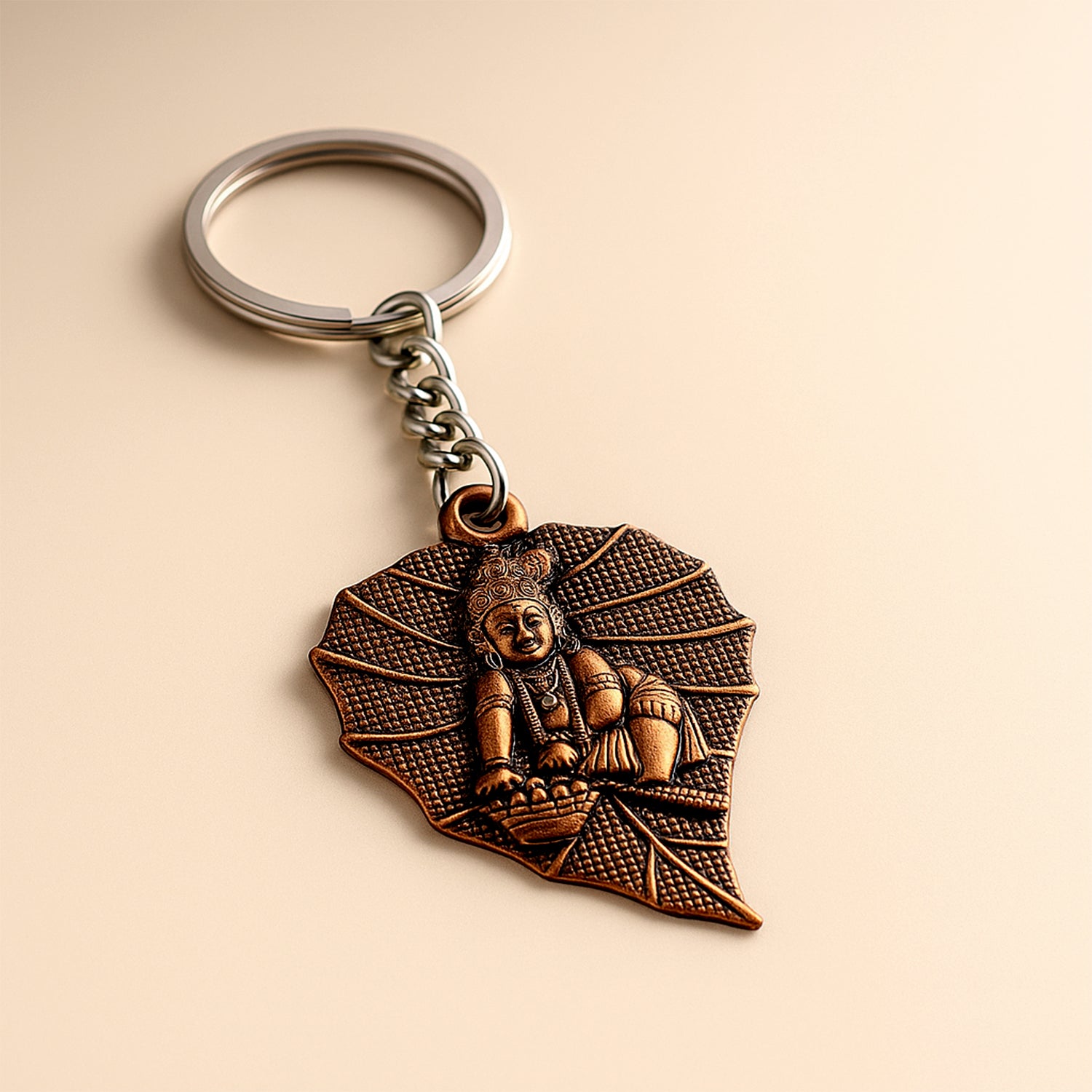 Antique-finish metal keychain by Wukusy with intricate design, featuring a durable metal loop for keys or accessories.