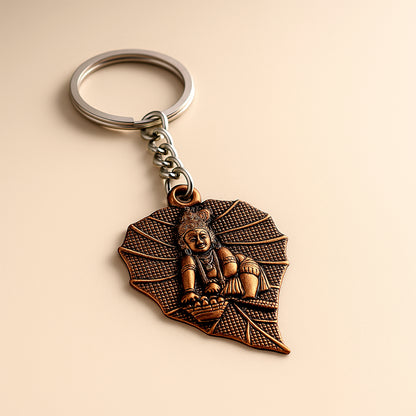 Antique-finish metal keychain by Wukusy with intricate design, featuring a durable metal loop for keys or accessories.