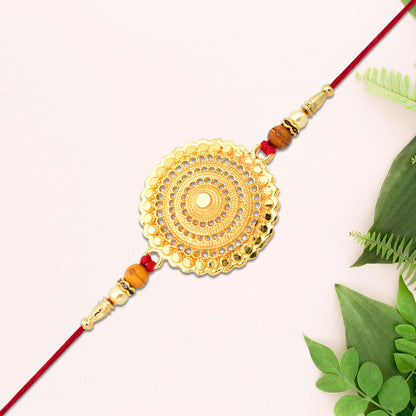 Golden Mandala Designer Rakhi by Wukusy featuring intricate mandala patterns and vibrant gold accents for festive celebrations.