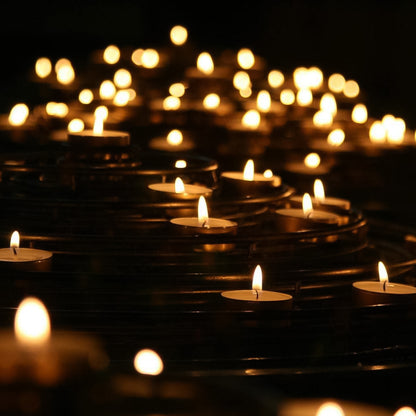 Set of 50 smokeless tealight candles from Wukusy, showing small, round tealights with teal-colored wax and metal bottoms.