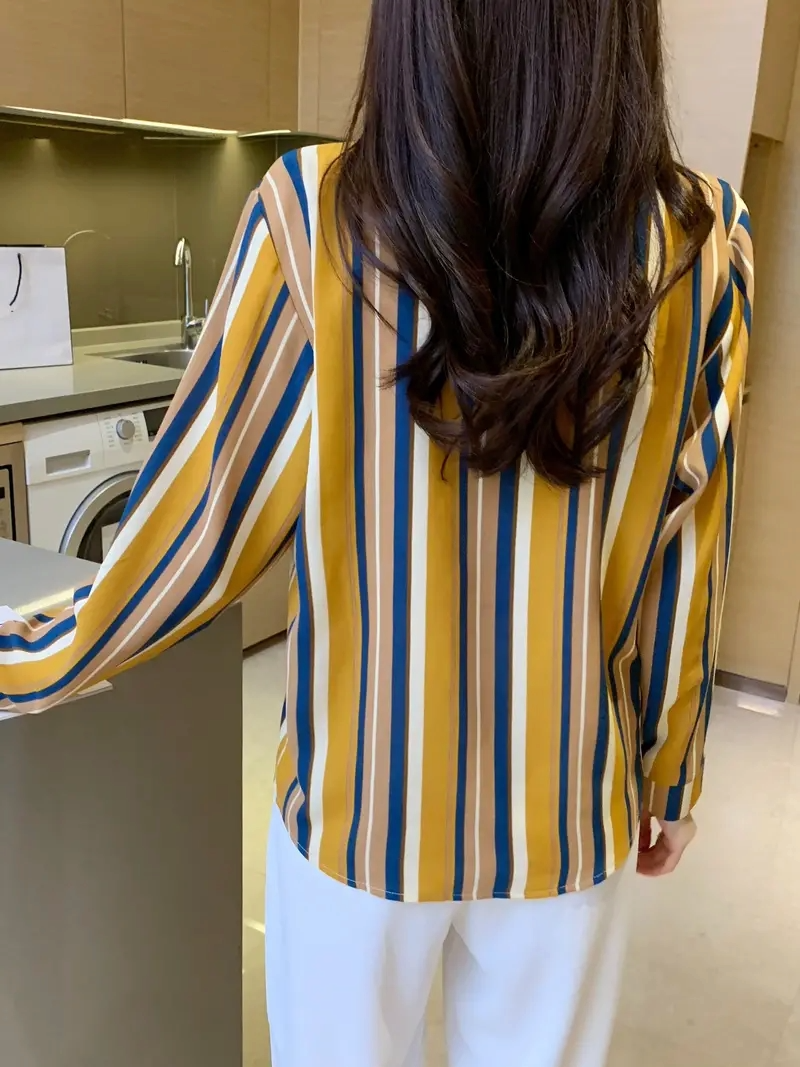 Woman wearing a striped print cotton silk long sleeve tunic shirt with collar from Drpshippr's men's collection.