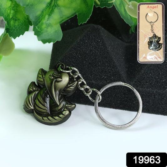 Antique black metal Ganesh face keychain by Wukusy, featuring detailed Hindu deity design on a compact key accessory.