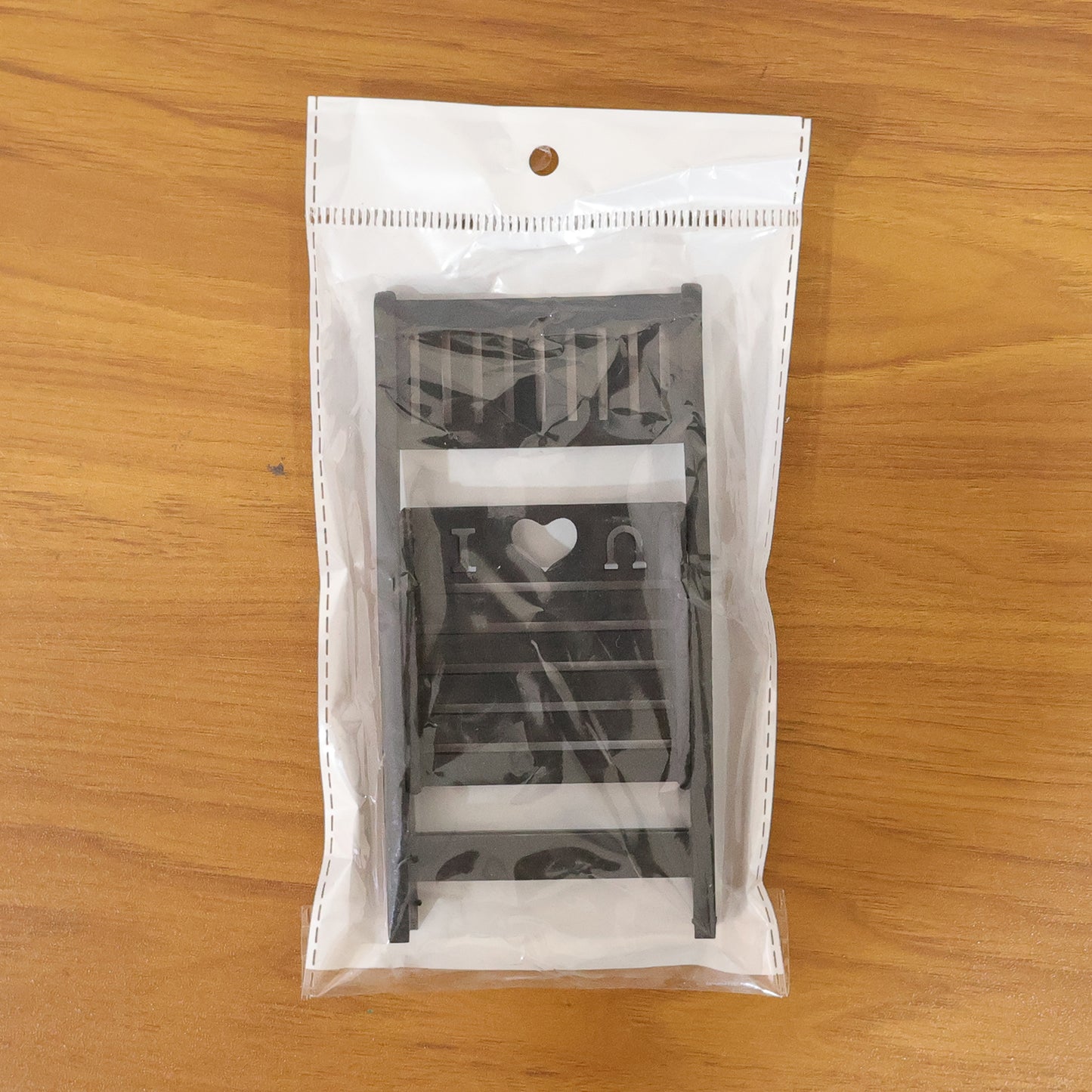 Black mini chair-shaped mobile stand holder by Wukusy, compact and durable for holding smartphones securely.
