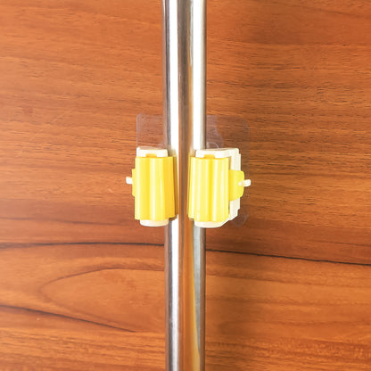 Wukusy Magic Sticker Series self-adhesive mop and broom holder for home organization, mounted on a wall with cleaning tools.