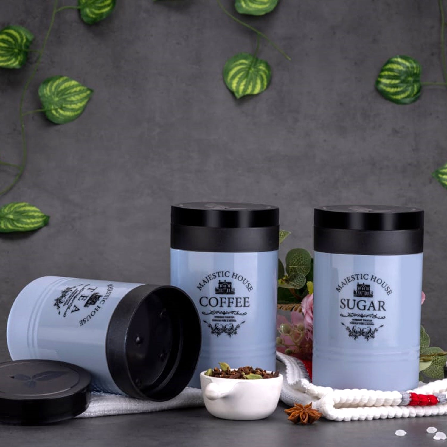 Set of three Wukusy plastic airtight Damru-shaped containers for tea, coffee, sugar, salt, and dry fruits in multicolor.
