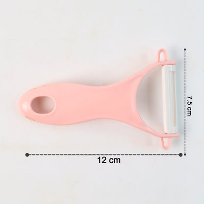 Wukusy stainless steel blade peeler for kitchen, versatile design for professional and household use, shown with peelings