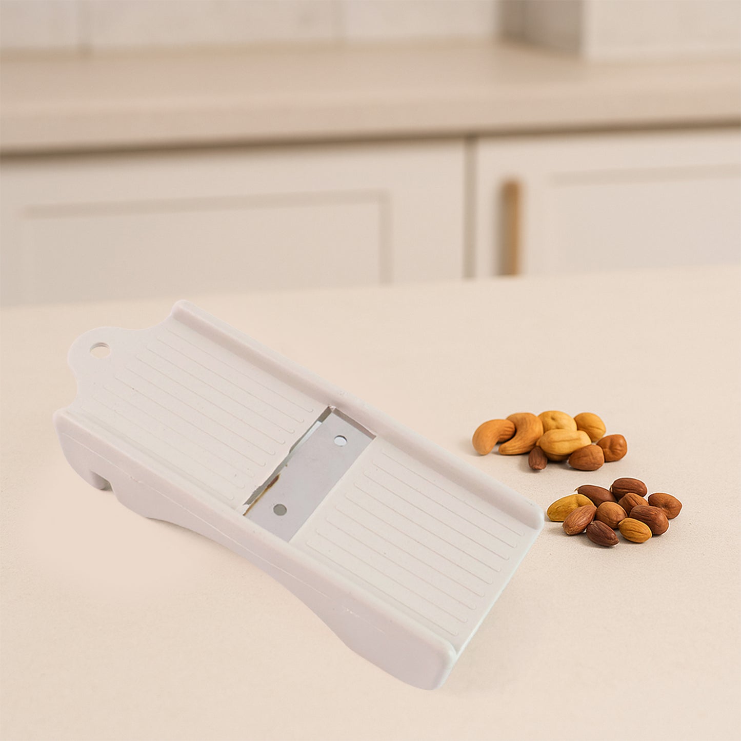 Wukusy Liger multipurpose dry fruit and ginger slicer on a kitchen countertop, showing sharp blades for home food preparation.