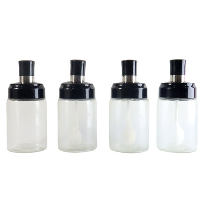 Set of four transparent Wukusy spice jars with airtight lids and spoons, ideal for organizing spices in a home kitchen.