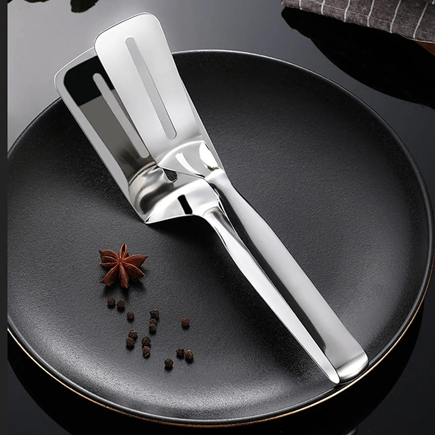 Wukusy stainless steel multifunction cooking and serving turner with food tongs, ideal for frying, grilling, and BBQ kitchen use.