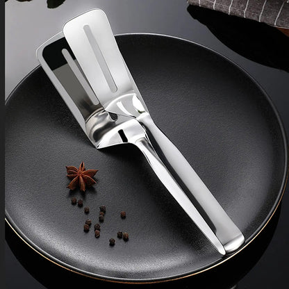 Wukusy stainless steel multifunction cooking and serving turner with food tongs, ideal for frying, grilling, and BBQ kitchen use.