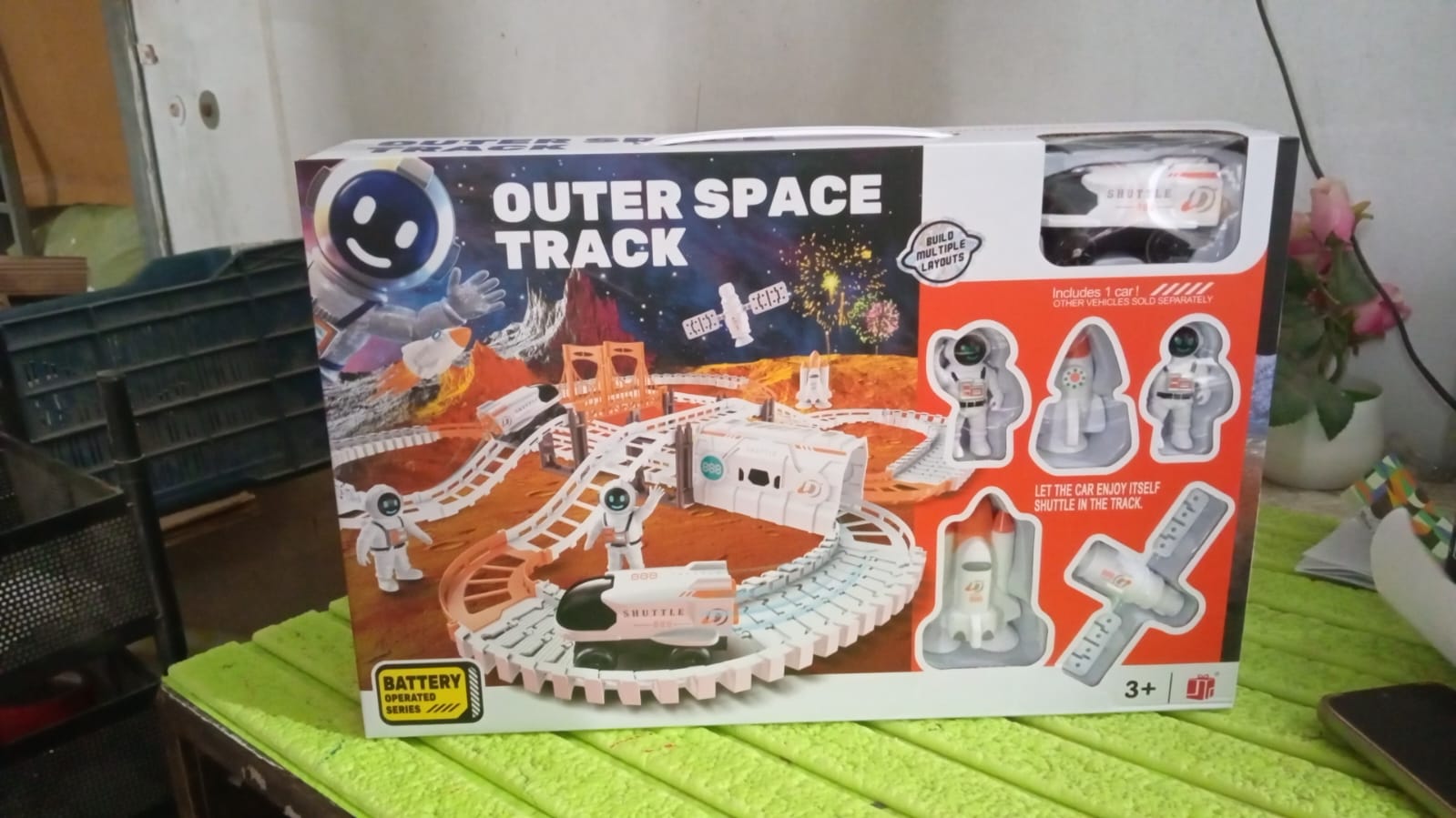 Wukusy outer space race track set for kids toys with colorful space-themed race cars and track pieces on a play mat.