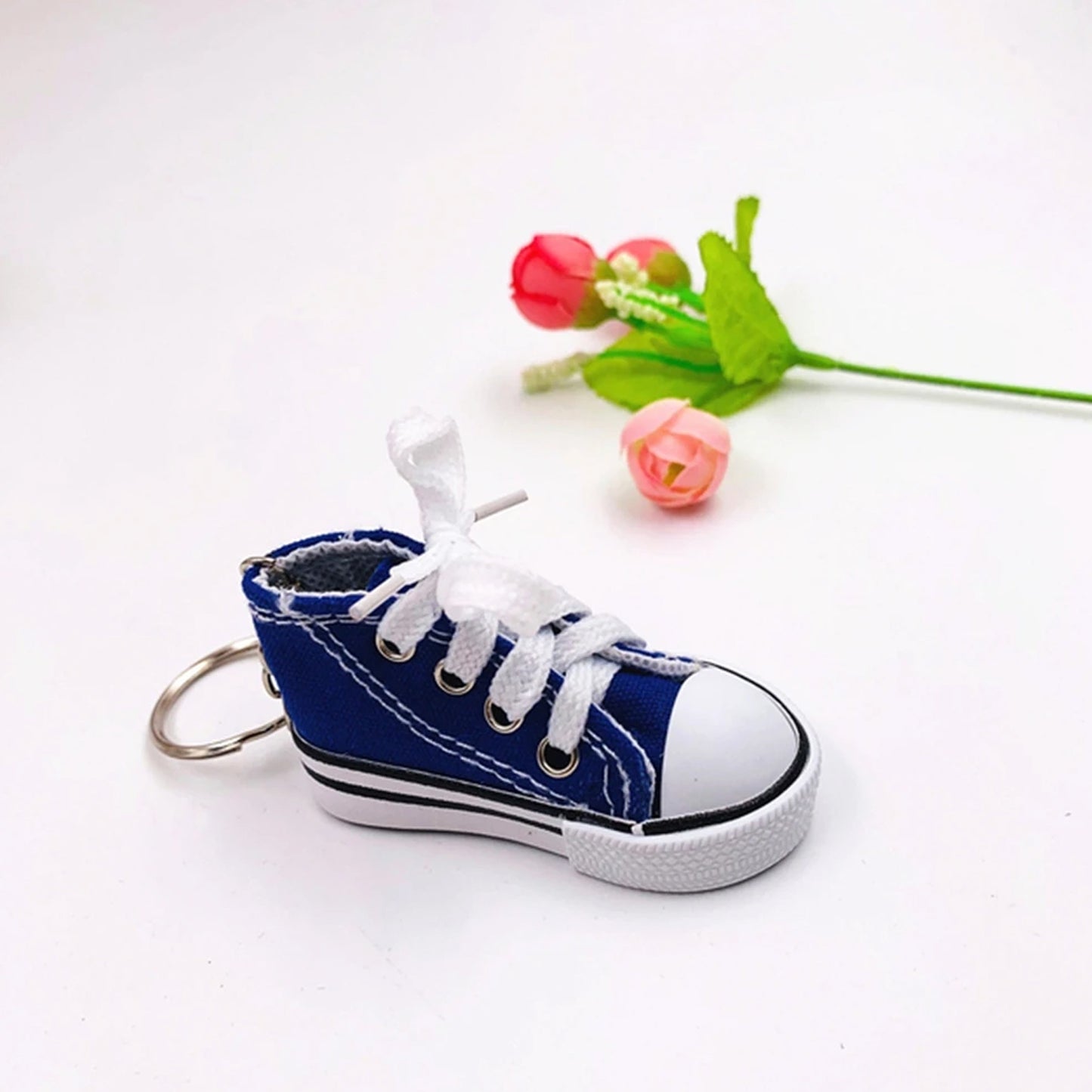 Wukusy Mini Shoes Keychain, stylish travel accessory for backpacks, featuring a small, detailed shoe design.