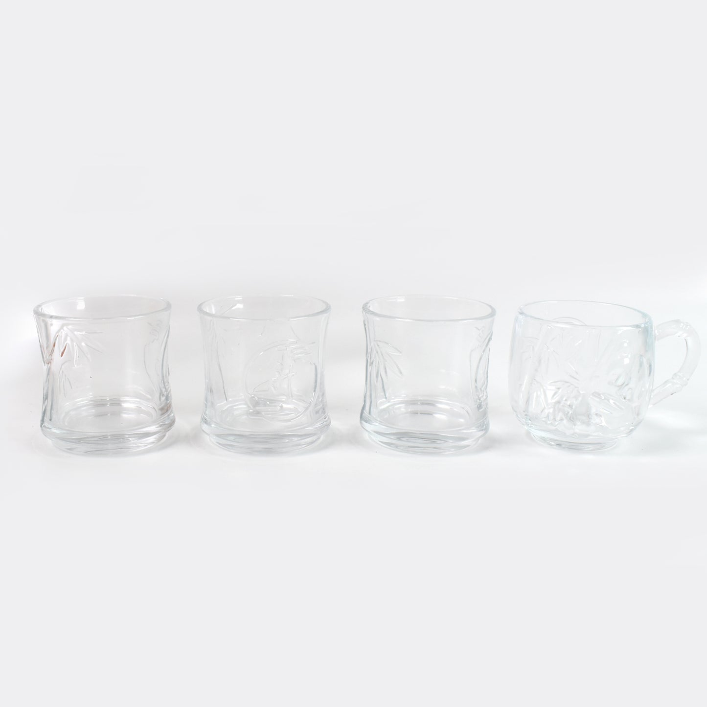 Set of four Wukusy glass tumblers and cups, clear 3-piece and 1-piece set, showcasing sleek, transparent glassware for beverages.