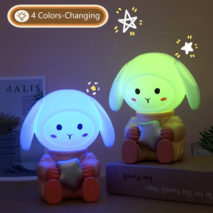 Wukusy rabbit LED night light with mobile phone stand on bedroom or study table, soft glow, child-friendly design